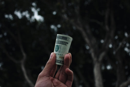 Money rolled up in hand.